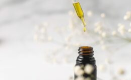 clear glass bottle with yellow lid